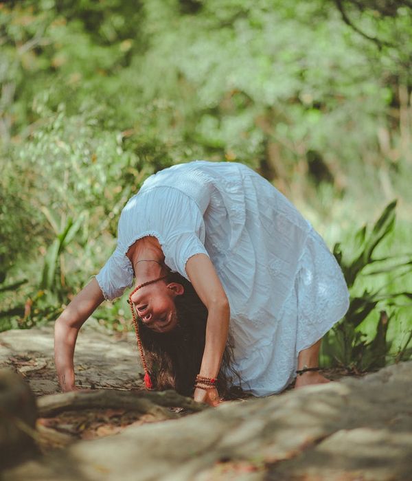 A person in a calm yoga pose, surrounded by a serene environment.